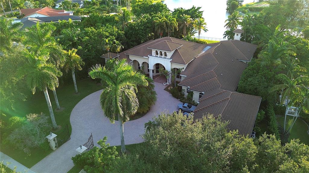 An aerial view of a large house with a tile roof and a circular driveway — 471 RANCH ROAD, WESTON, FL