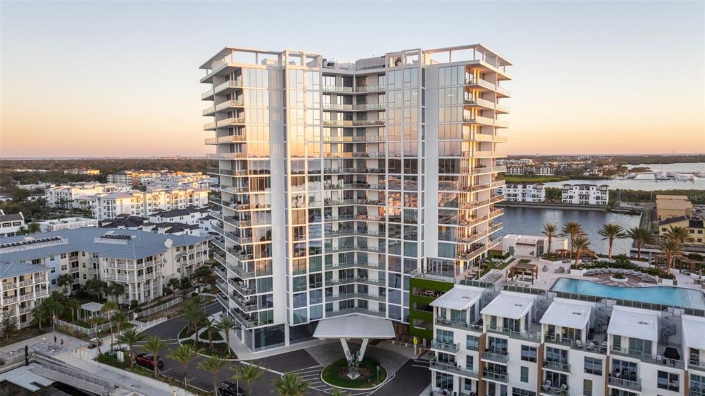 An aerial view of a modern high-rise apartment building with balconies and a swimming pool — 5120 MARINA WAY UNIT 16002, TAMPA, FL