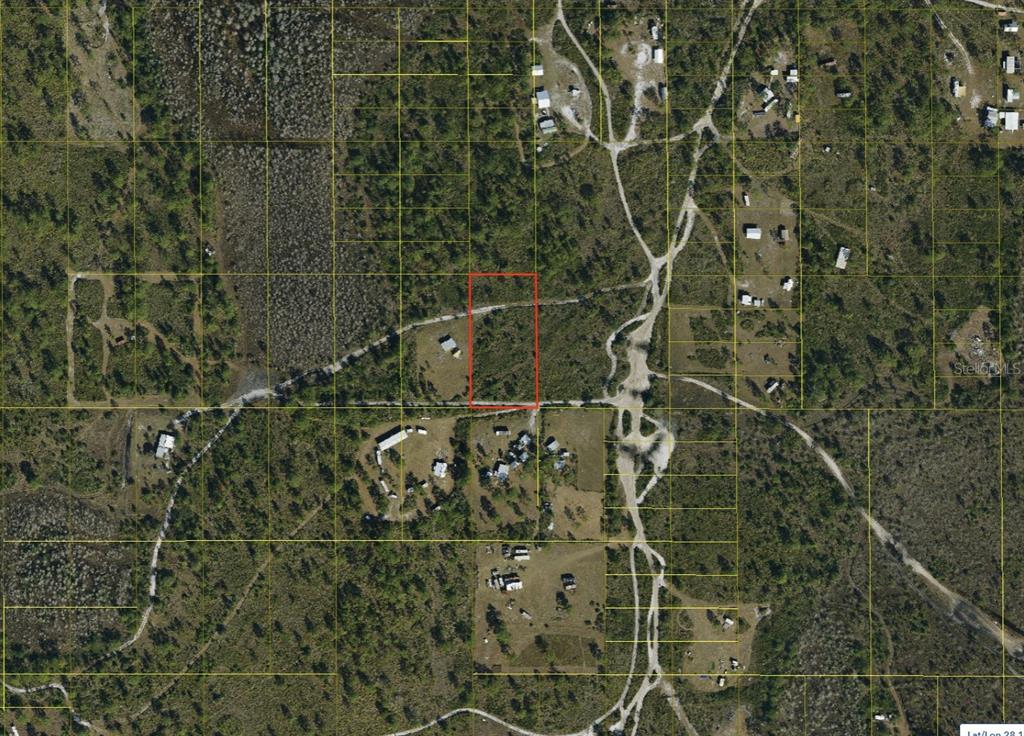 An aerial map shows a rectangular parcel of land outlined in red amidst rural vegetation — SUBURBAN ESTS SEC 25...2332 003D, ST CLOUD, FL