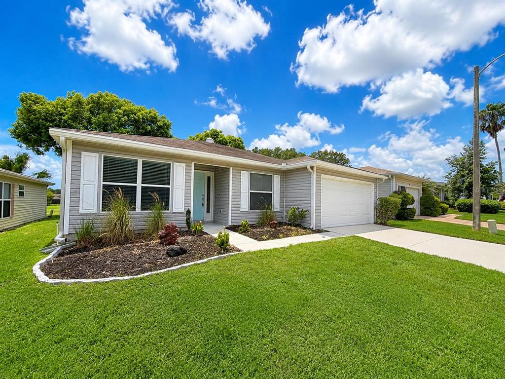 A single-story house with light gray siding, a white garage door, and a front lawn — 29204 PRINCEVILLE DRIVE, SAN ANTONIO, FL