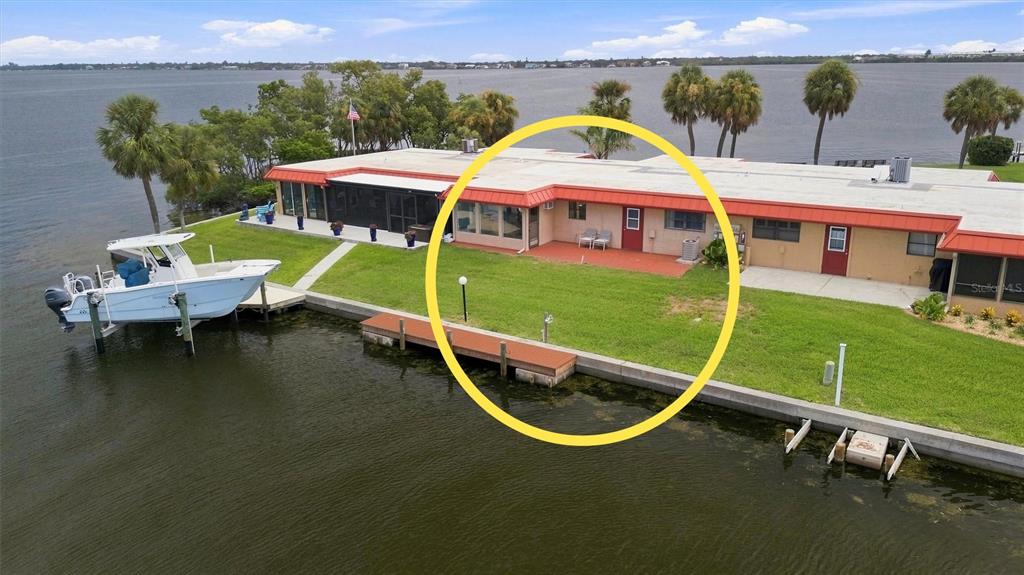 An aerial view of a waterfront house with a red roof and a patio area — 3840 CATALINA DRIVE, BRADENTON, FL