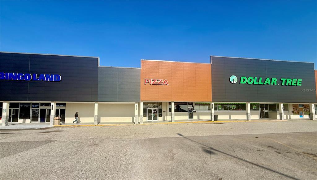 A strip mall exterior features a Bingo Land, a pizza restaurant, and a Dollar Tree — 6830 14TH STREET W UNIT A, BRADENTON, FL