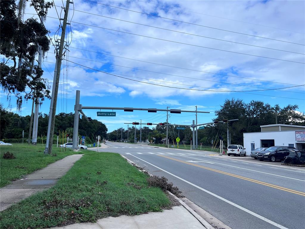 A street intersection with traffic lights and a street sign labeled Betty Lane — 1302 SUNSET PT RD, CLEARWATER, FL