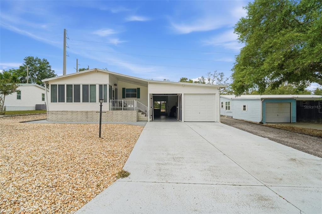 A single-story house with a white exterior, a screened-in porch, and an attached garage — 30 FLORENCE BOULEVARD, DEBARY, FL