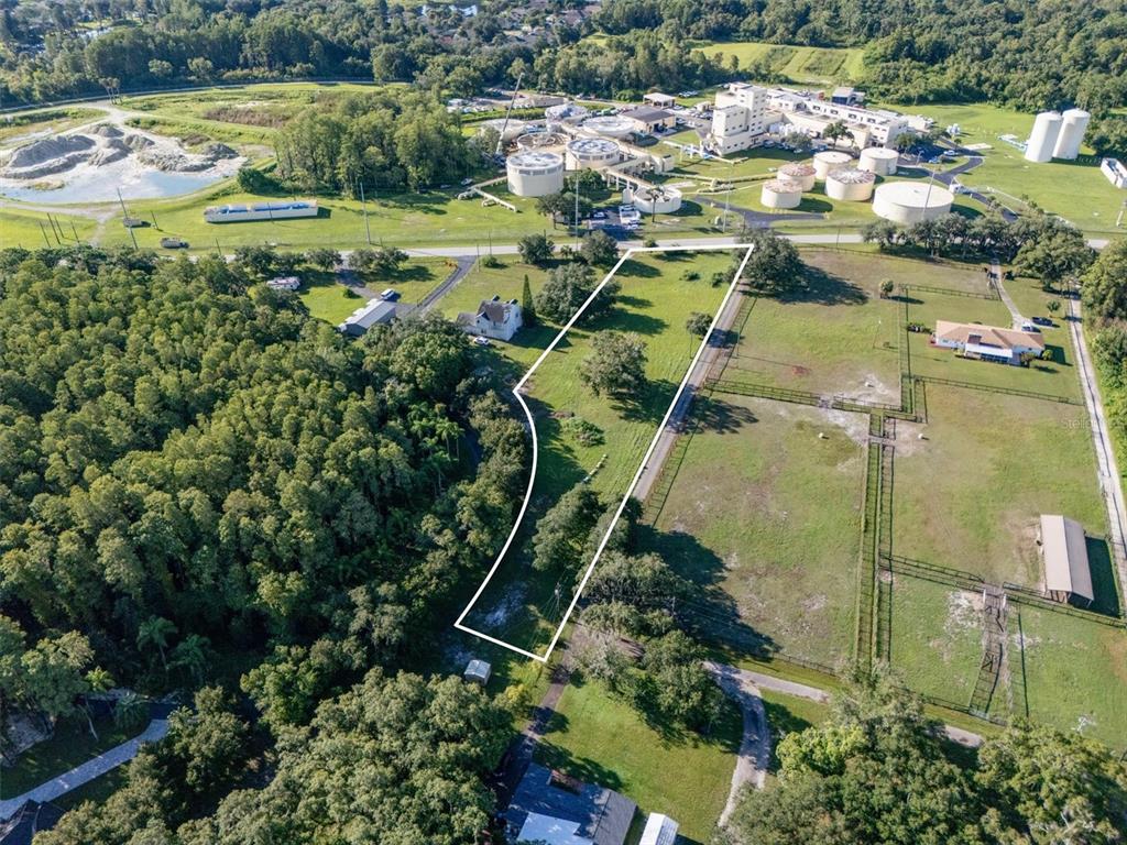An aerial view shows a rectangular plot of land outlined in white near a facility — 0 MILAM DRIVE, ODESSA, FL