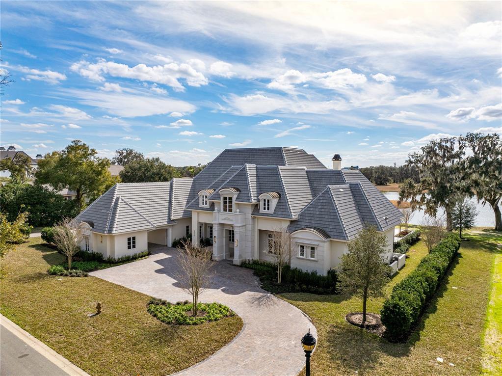 An aerial view shows a large, light-colored house with a gray tile roof and driveway — 8570 NW 31ST LANE ROAD, OCALA, FL