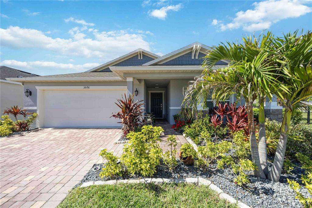 A single-story house with a paved driveway, a two-car garage, and a landscaped front yard — 3576 74TH AVENUE CIRCLE E, SARASOTA, FL
