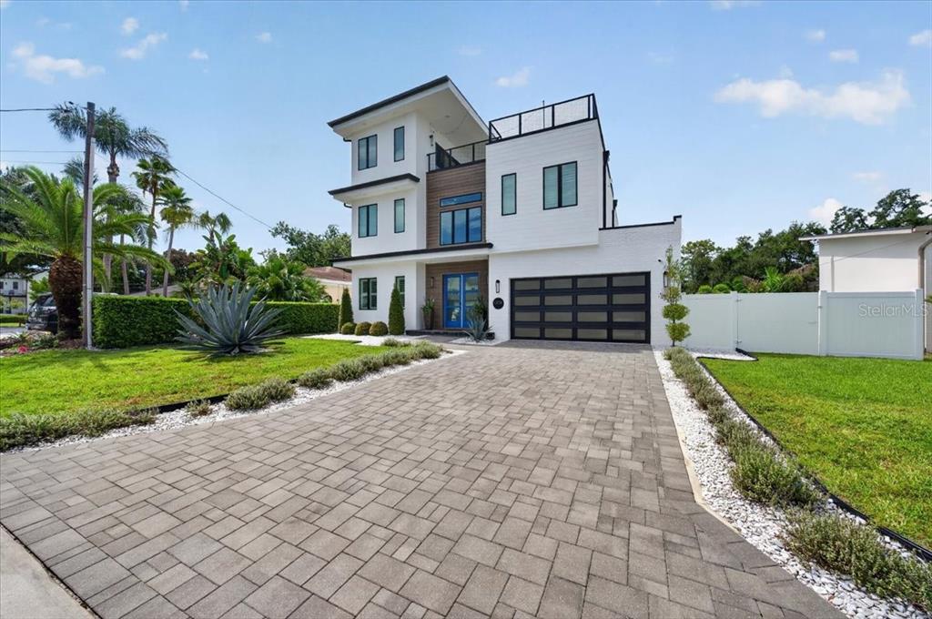 A modern white house with a swimming pool and a large grassy backyard — 1308 W PLYMOUTH STREET, TAMPA, FL