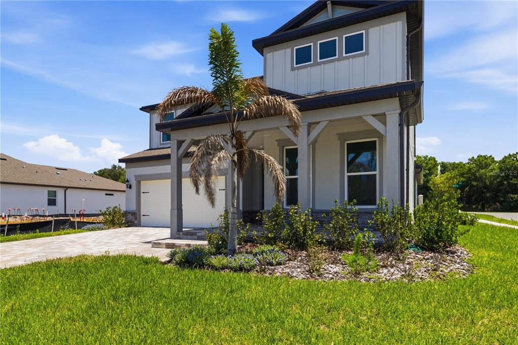 A two-story house with a gray exterior, a front porch, and a palm tree — 13824 SUNLIGHT MEADOW DRIVE, RIVERVIEW, FL