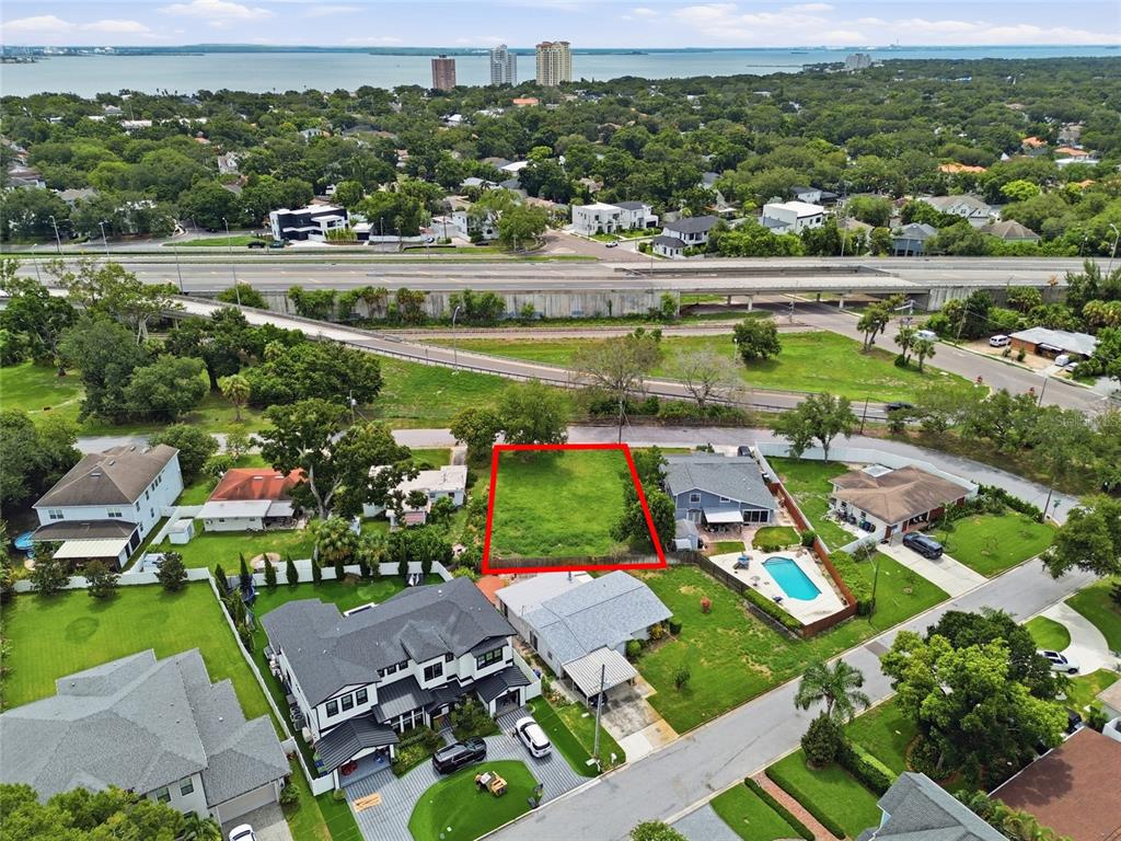 An aerial view shows a vacant rectangular lot outlined in red within a residential neighborhood — 3615 S CONCORDIA AVENUE, TAMPA, FL