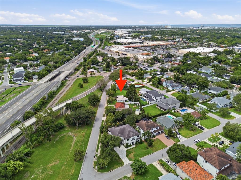 An aerial view shows a residential neighborhood with a red arrow pointing to a vacant lot — 3615 S CONCORDIA AVENUE, TAMPA, FL