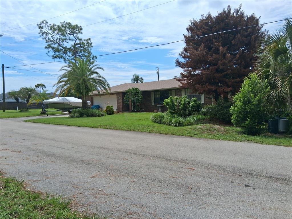 A single-story brick house with a two-car garage and a boat parked on the lawn — 400 W ORANGE STREET, ALTAMONTE SPRINGS, FL