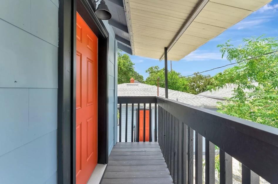 A sunroom with wood-look flooring, a gray desk, and multiple windows with white blinds — 828 22ND AVENUE N UNIT 1/2, ST PETERSBURG, FL