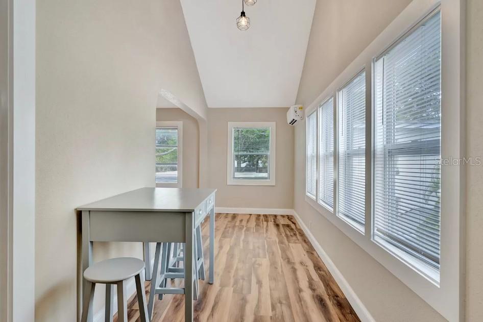 An interior view shows a living area with light wood flooring, arched transitions, and vaulted ceilings — 828 22ND AVENUE N UNIT 1/2, ST PETERSBURG, FL