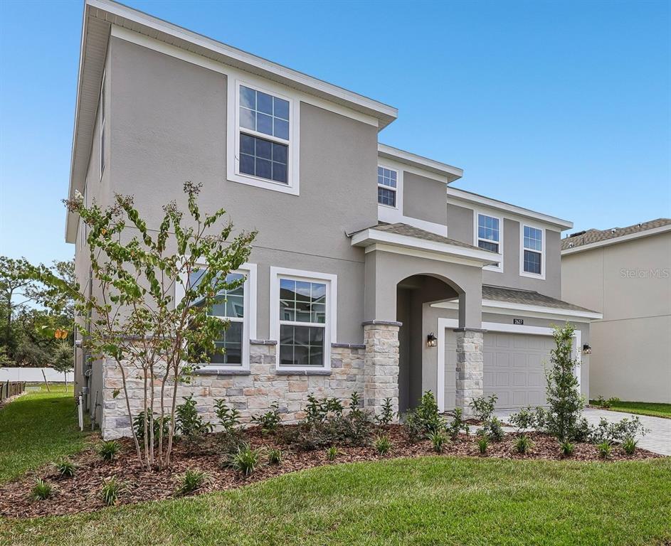An outdoor park area features concrete walkways, picnic tables, and young trees on a lawn — 2627 CAVANAUGH DRIVE, ORLANDO, FL