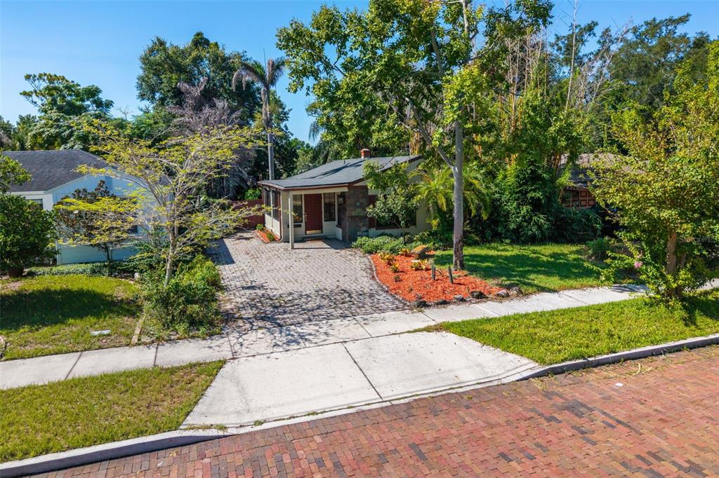 The front entrance features a covered porch, a red door, and stone siding — 1710 OREGON STREET, ORLANDO, FL