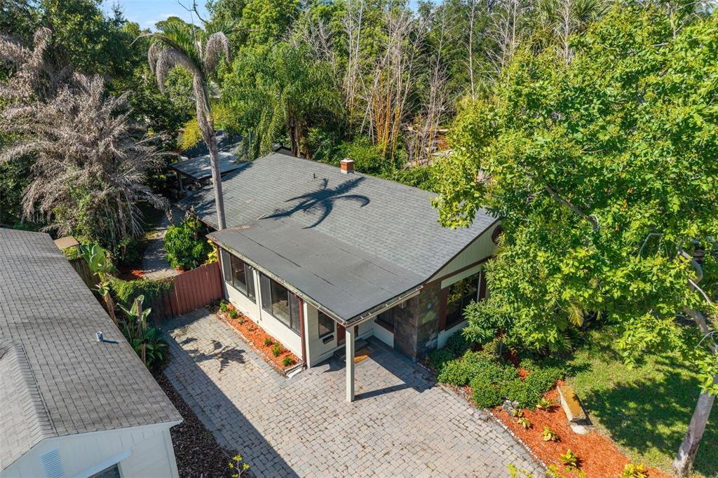 A living room with dark walls, hardwood floors, a sectional sofa, and two ceiling fans — 1710 OREGON STREET, ORLANDO, FL