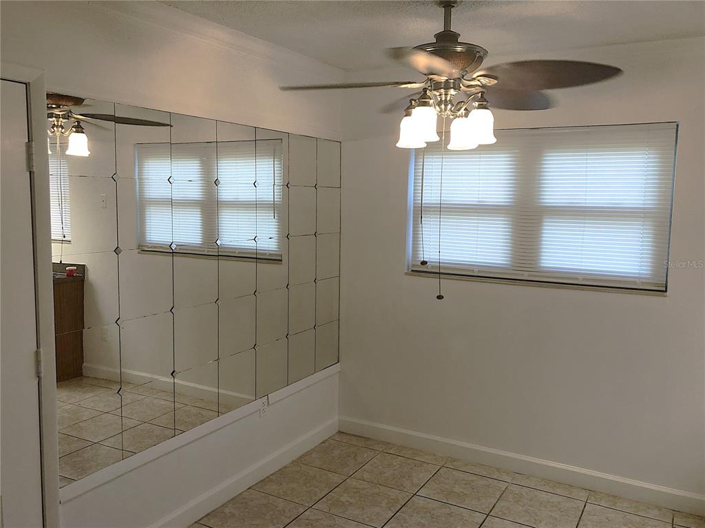 A kitchen features dark wood cabinets, white appliances, and speckled laminate countertops — 2545 OAK PARK WAY UNIT 118, ORLANDO, FL