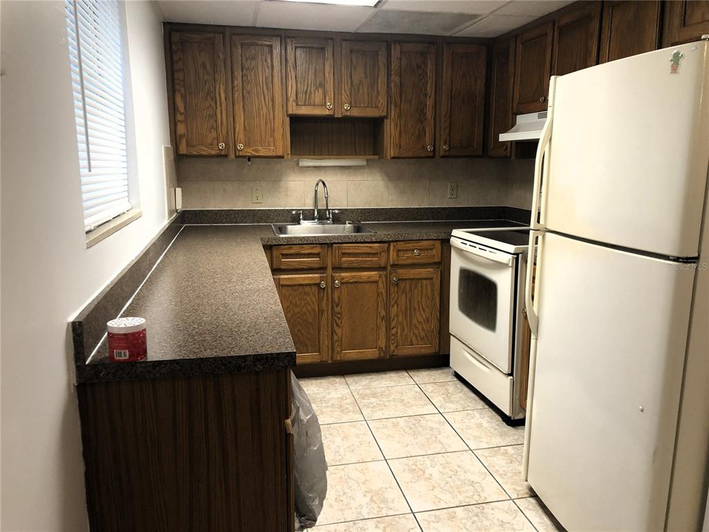 An empty room with white walls and light-colored square floor tiles — 2545 OAK PARK WAY UNIT 118, ORLANDO, FL