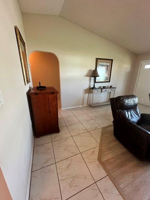 A room with tiled floors, a wooden cabinet, a console table, and a leather recliner — 4310 VANTAGE CIRCLE, SEBRING, FL