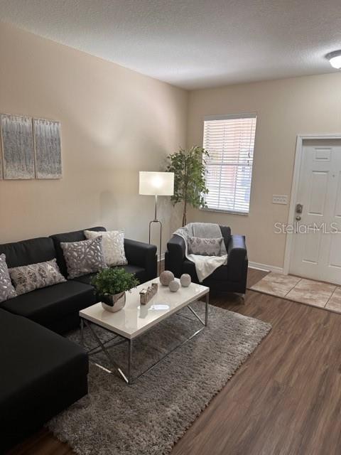 A living room features a black sectional sofa, a white coffee table, and a front door — 11048 SAVANNAH LANDING CIRCLE, ORLANDO, FL