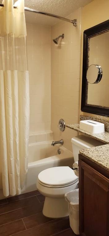 A bathroom features a white toilet, a bathtub with a shower, and a granite vanity — 3200 RIVER RANCH BOULEVARD UNIT 225, RIVER RANCH, FL