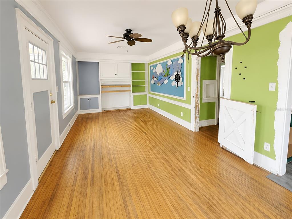 An empty bedroom features light green walls, hardwood floors, a ceiling fan, and two closets — 1037 LEXINGTON STREET, LAKELAND, FL