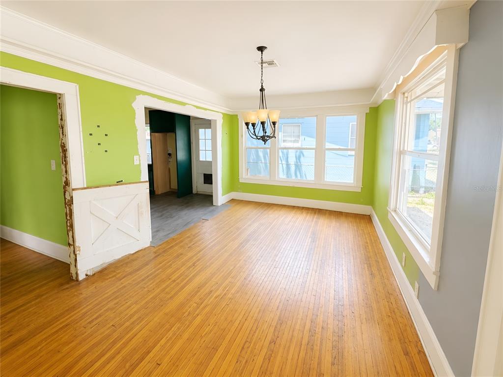 An empty bedroom features blue walls, hardwood floors, a ceiling fan, and two white doors — 1037 LEXINGTON STREET, LAKELAND, FL