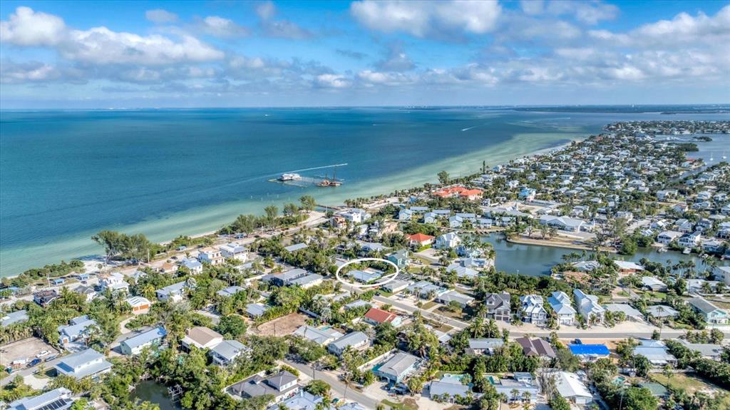An aerial view shows a residential neighborhood near the coast with a circled house — 154 CRESCENT DRIVE, ANNA MARIA, FL