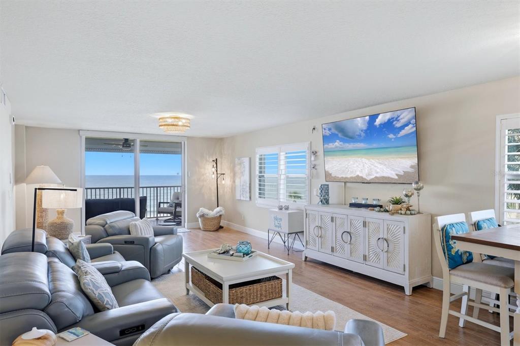A kitchen features a granite-topped island, stainless steel appliances, and light-colored cabinetry — 4325 GULF OF MEXICO DRIVE UNIT 408, LONGBOAT KEY, FL