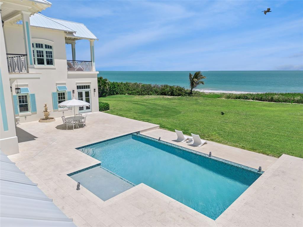 A multi-story house with a pool, patio, and lawn overlooking the ocean — 716 REEF ROAD, VERO BEACH, FL