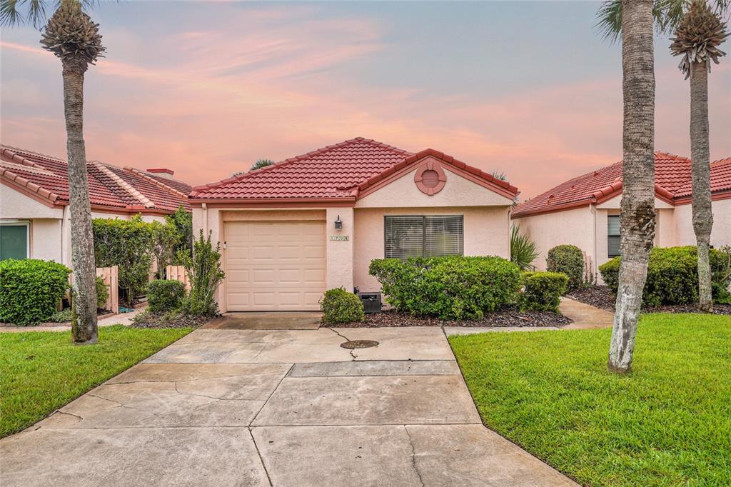 A single-story house with a red tile roof, a one-car garage, and a concrete driveway — 1704 SEA FAIR DRIVE, ST AUGUSTINE, FL