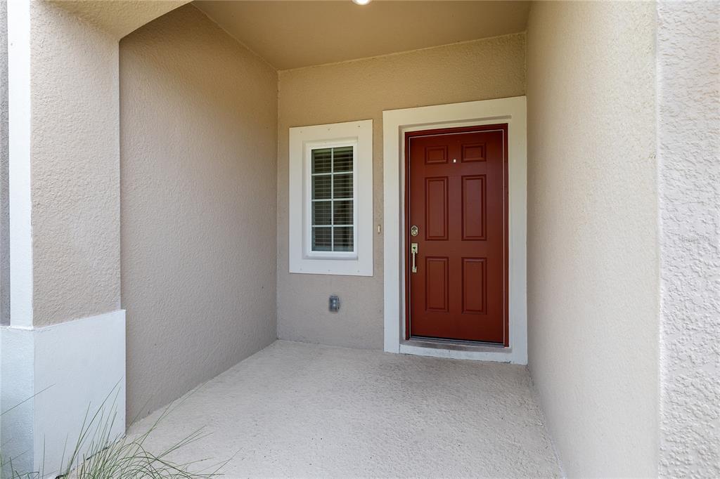 A modern kitchen features white cabinets, a central island, and sliding glass doors to outdoors — 5780 HAVEN TERRACE, NOKOMIS, FL