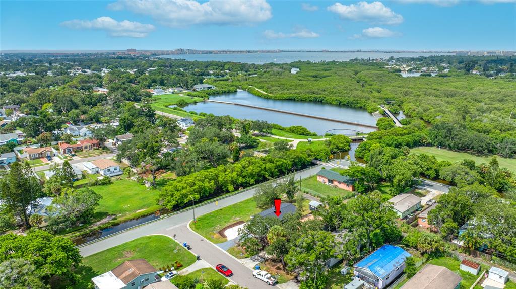 An aerial view shows a residential neighborhood with a red arrow pointing to a house — 2547 KINGSTON STREET S, ST PETERSBURG, FL