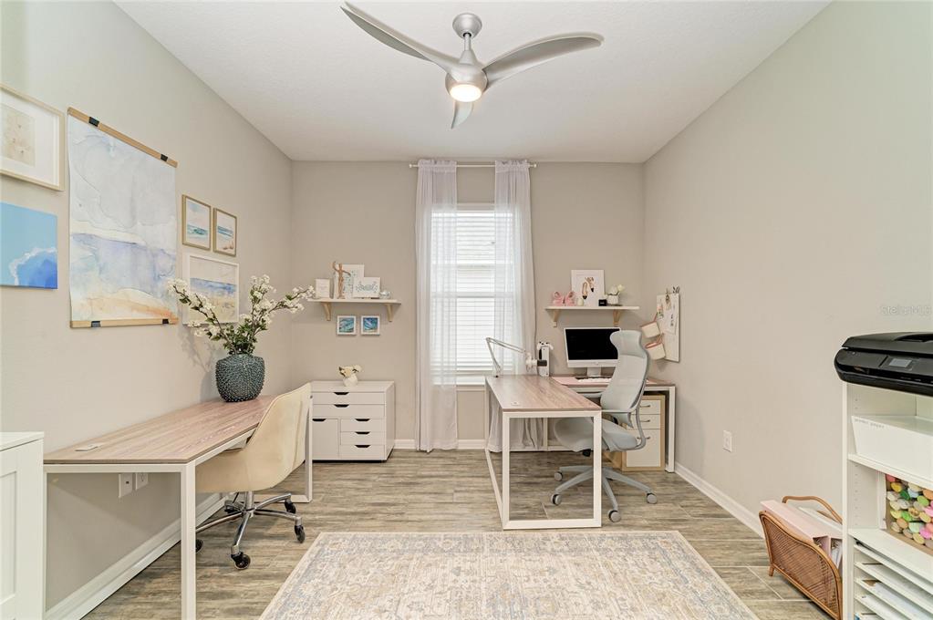 A home office features two desks, a ceiling fan, a window with curtains, and tile flooring — 4714 ROYCROFT TERRACE, PARRISH, FL