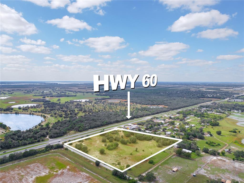 An aerial view shows a vacant, rectangular plot of land adjacent to a highway — STATE ROAD 60 E, LAKE WALES, FL