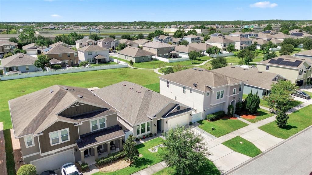 An aerial view shows several suburban houses with shingled roofs and green lawns — 2050 BEACON LANDING CIRCLE, ORLANDO, FL