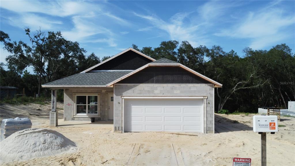 A single-story house under construction with concrete block walls and a white garage door — 34281 MANUEL STREET, WEBSTER, FL