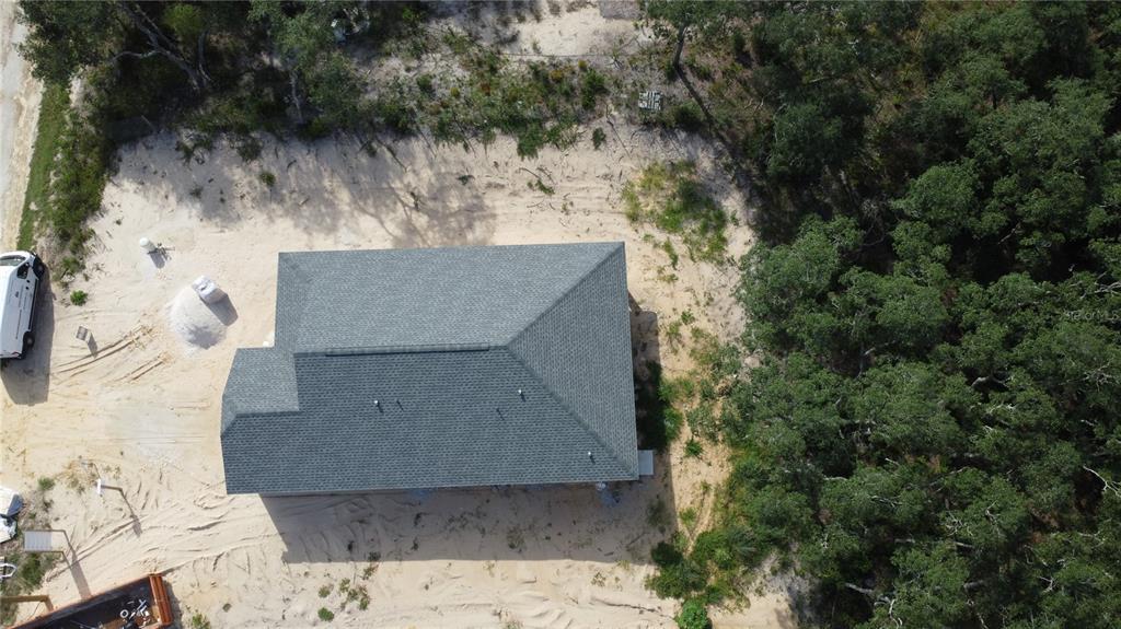 An unfinished room with light blue walls, two windows, and construction materials on the floor — 34281 MANUEL STREET, WEBSTER, FL