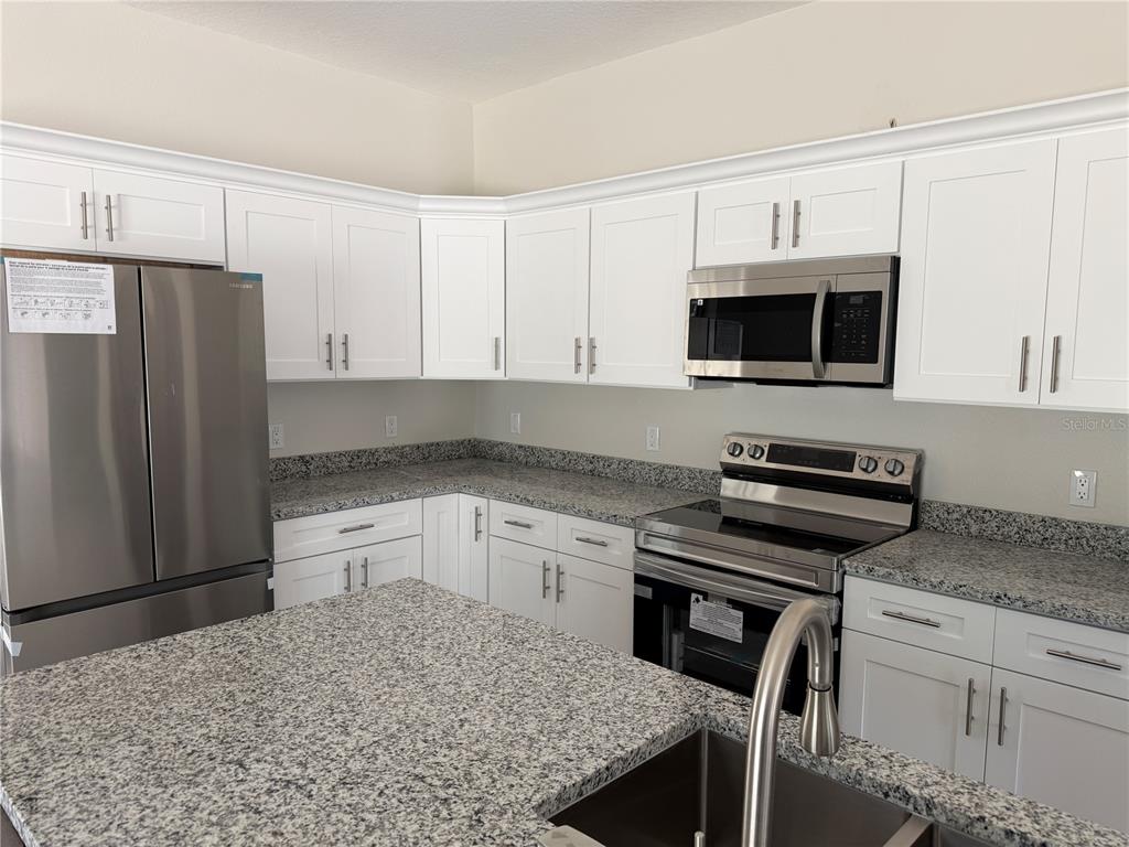 An unfinished room with light blue walls, a window, and a recessed alcove — 34281 MANUEL STREET, WEBSTER, FL