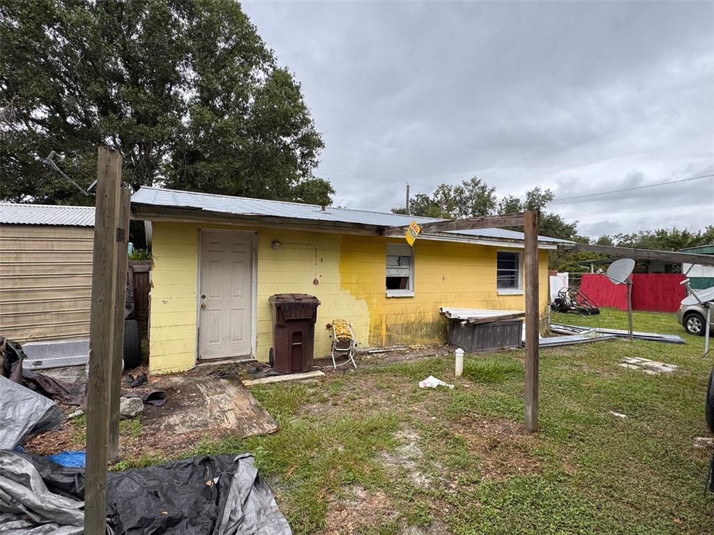 The exterior of a yellow, single-story concrete block building with a metal roof — 2293 PUMP ROAD, MULBERRY, FL