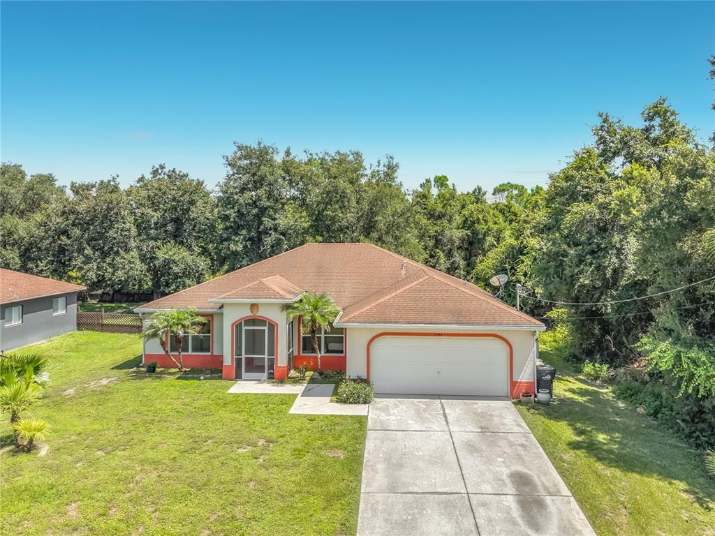 A single-story house with a two-car garage, a front porch, and a concrete driveway — 3344 PERICLES AVENUE, NORTH PORT, FL