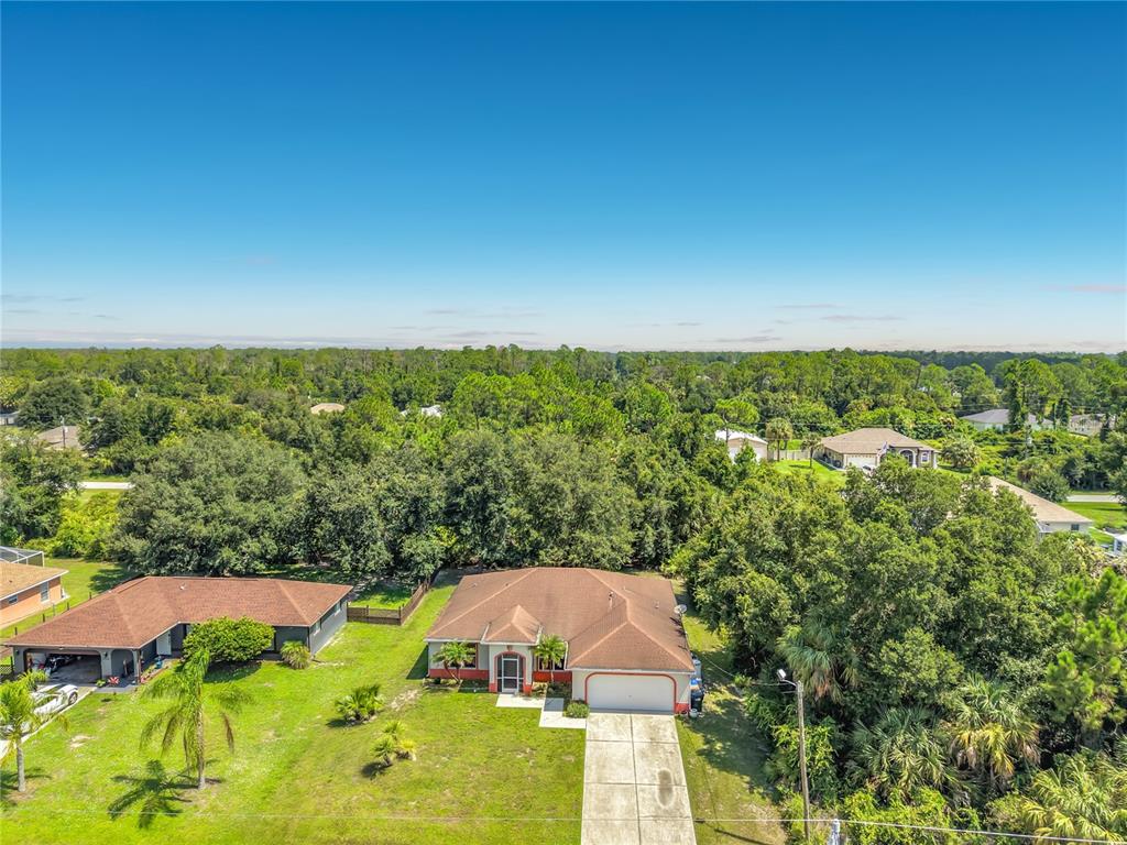 An aerial view shows a single-story house with a brown roof and a concrete driveway — 3344 PERICLES AVENUE, NORTH PORT, FL