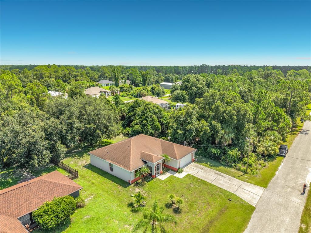 An aerial view shows a single-story house with a brown roof and a concrete driveway — 3344 PERICLES AVENUE, NORTH PORT, FL
