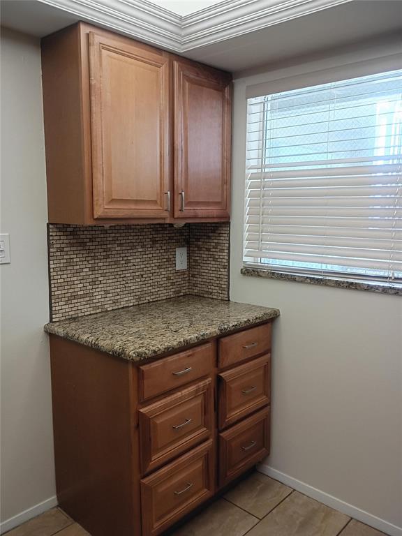 A kitchen features wood cabinets, granite countertops, stainless steel appliances, and a tiled backsplash — 1520 GLEN OAKS DRIVE E UNIT 248, SARASOTA, FL