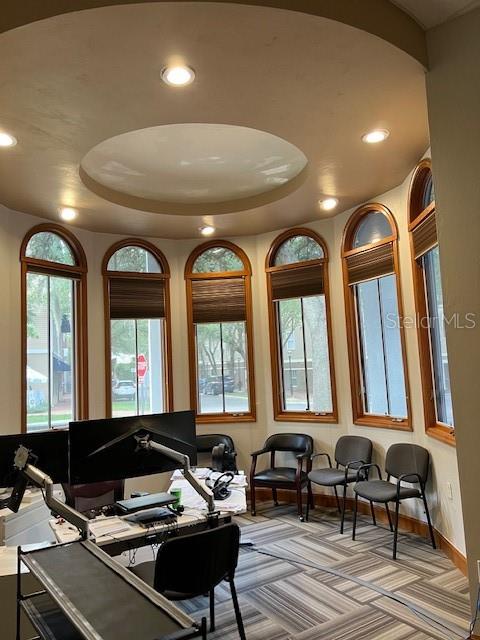 A curved office space features multiple windows, recessed lighting, and a desk with computer equipment — 4965 SW 91ST TERRACE, GAINESVILLE, FL