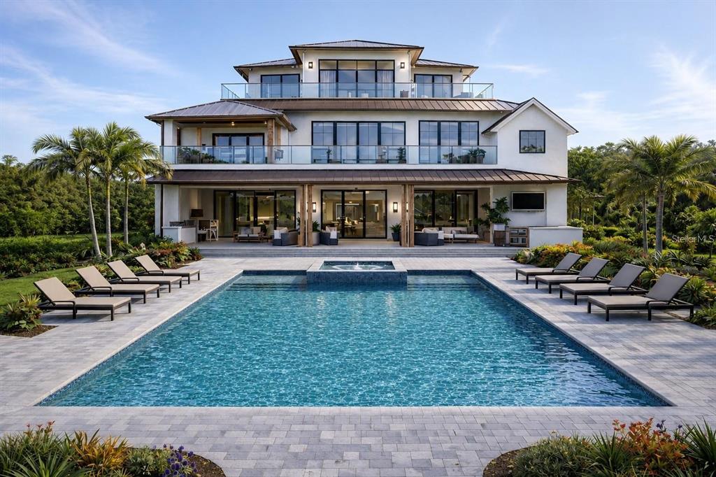 A three-story house with a swimming pool, patio, and lounge chairs in the backyard — 25 N WASHINGTON DRIVE, SARASOTA, FL