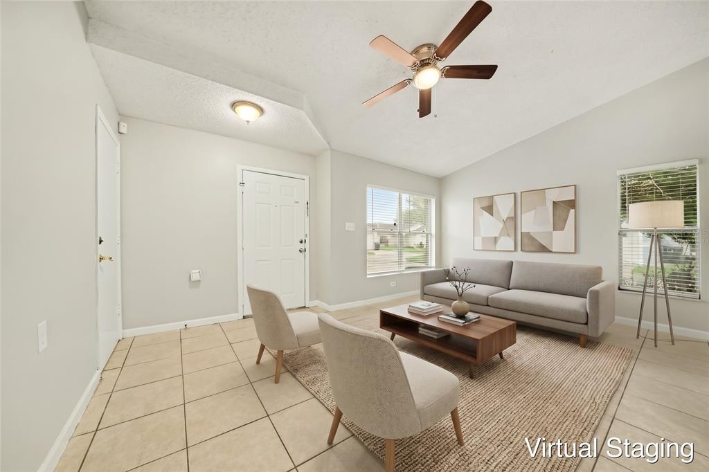 An empty room with light-colored tile flooring, a vaulted ceiling, and a ceiling fan — 1034 CLOVERCREST ROAD, ORLANDO, FL