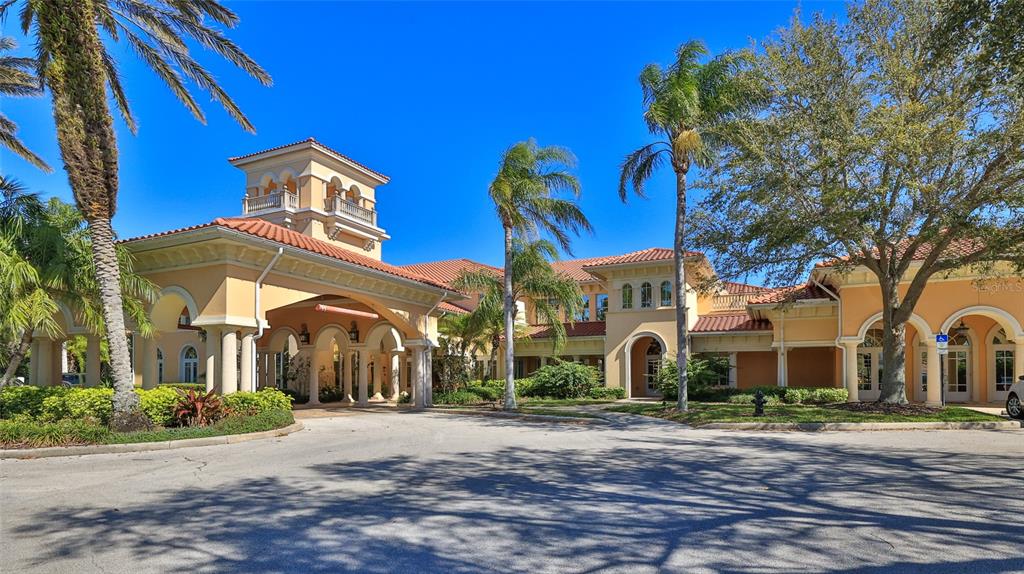 A large Mediterranean-style clubhouse with a porte-cochère, tile roof, and surrounding palm trees — 1 HAMMOCK BEACH PARKWAY, PALM COAST, FL