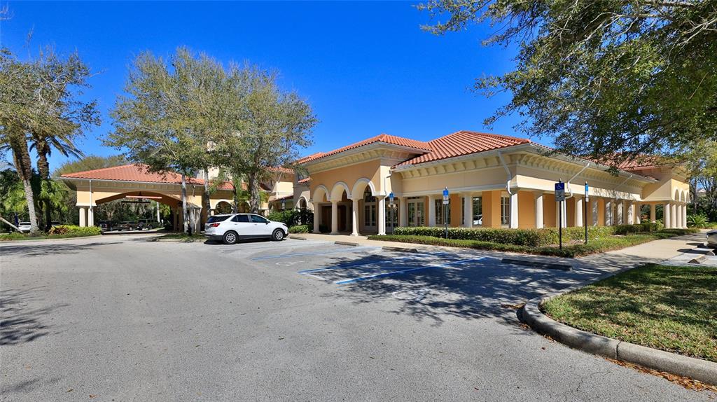 A white SUV is parked in front of a tan building with a tile roof — 1 HAMMOCK BEACH PARKWAY, PALM COAST, FL
